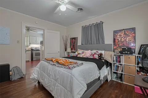 a bedroom with bed and a view of kitchen