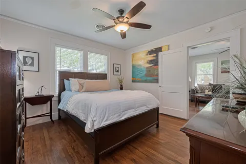 a spacious bedroom with a bed and large windows