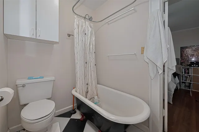 a bathroom with a toilet a sink and a shower