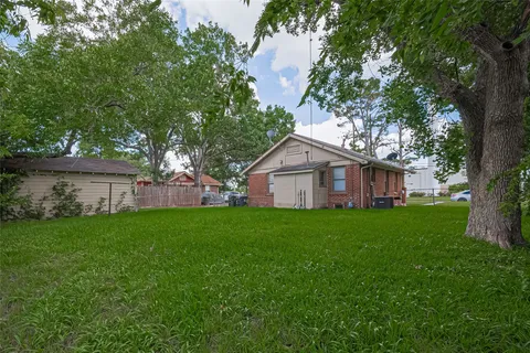 a view of a big yard with a house and garden