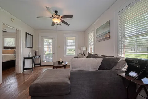 a living room with furniture and wooden floor