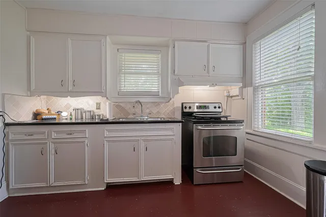 a kitchen with granite countertop a stove and a sink