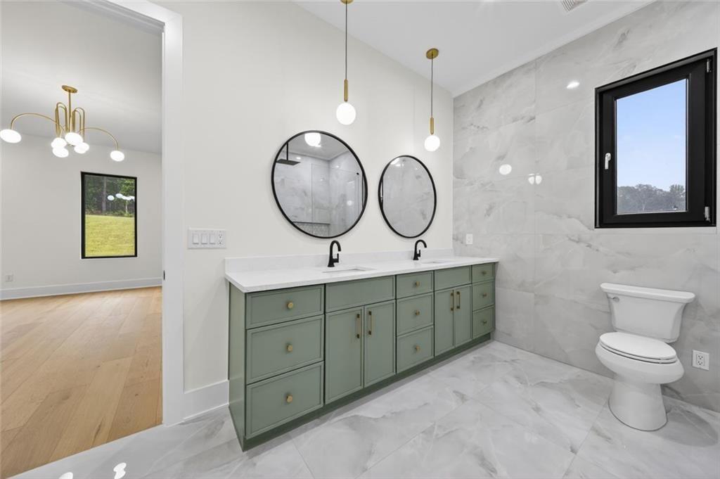 125 Rocky Rdg Way Auburn, GA 30011 - Photo 29 of 68 a spacious bathroom with a double vanity sink and a mirror