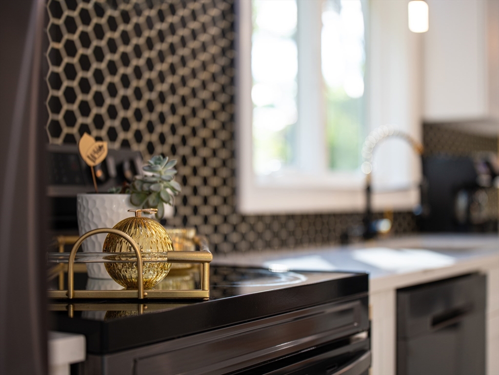 24 Miller Road Wilmington, MA 01887 - Photo 5 of 40 a kitchen with a sink a cabinets and window