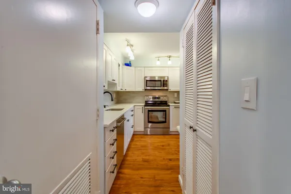 a kitchen with a sink and a stove top oven