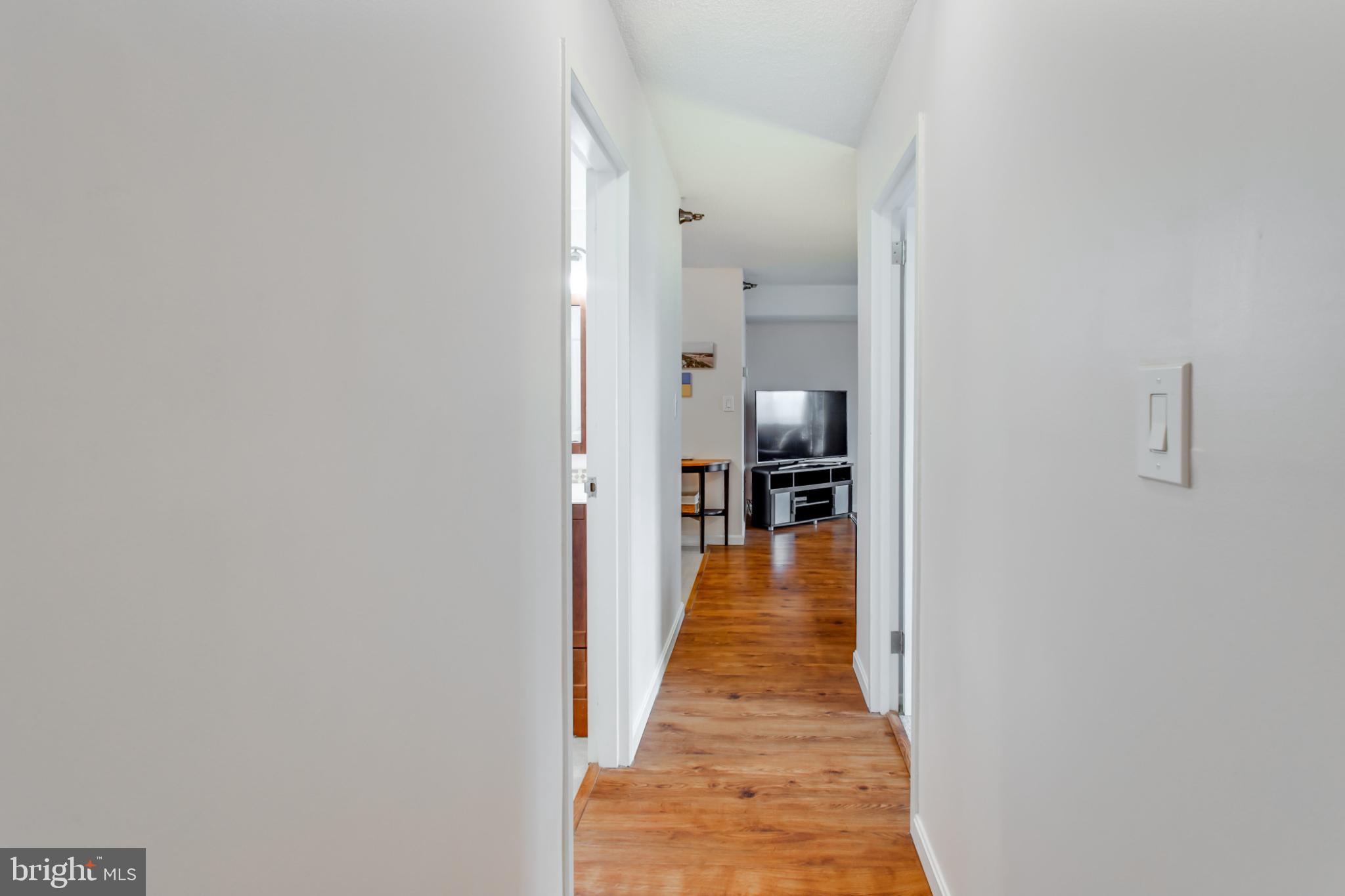1808 Old Meadow Road, Unit 1012 McLean, VA 22102 - Photo 32 of 62 Inviting hallway with warm wooden floors.