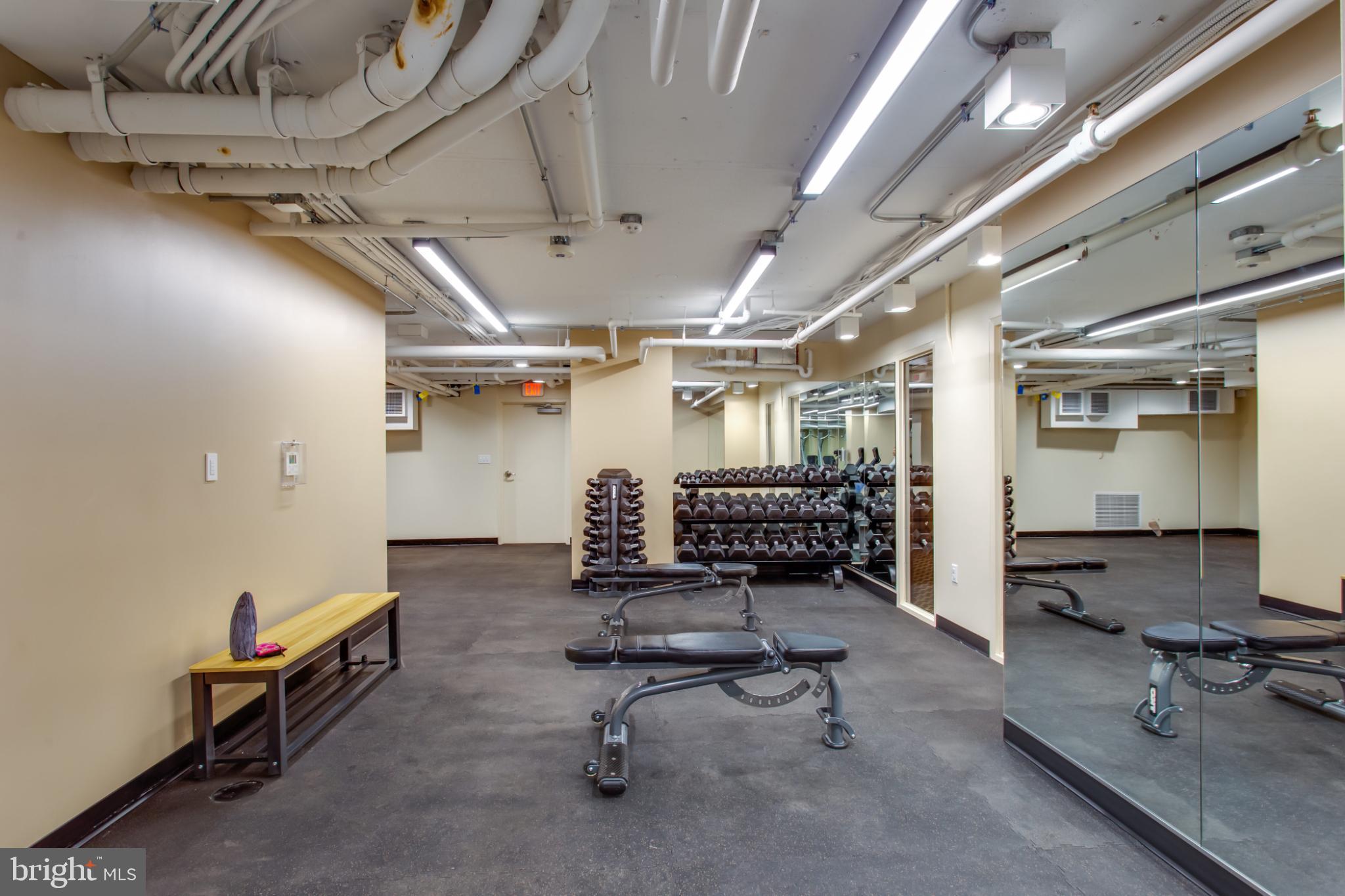 1808 Old Meadow Road, Unit 1012 McLean, VA 22102 - Photo 49 of 62 Modern fitness space with mirrored walls.