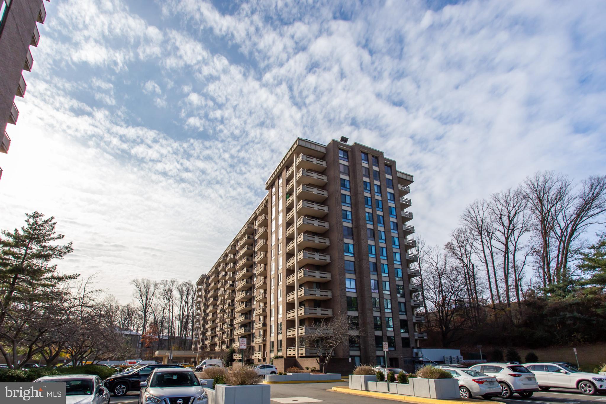 1808 Old Meadow Road, Unit 1012 McLean, VA 22102 - Photo 59 of 62 Modern apartment building under a vast sky.