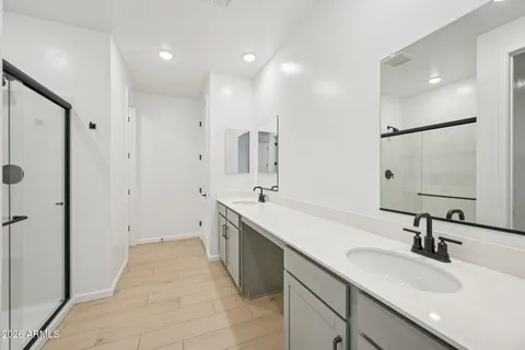 a spacious bathroom with a shower and a sink