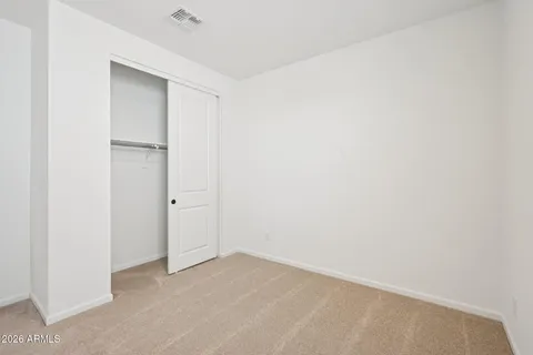 an empty room with white walls and tiles