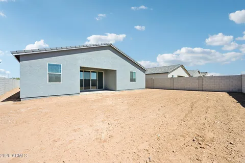 a view of a house with wooden fence