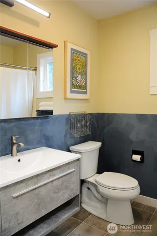 a bathroom with a toilet a sink and a window