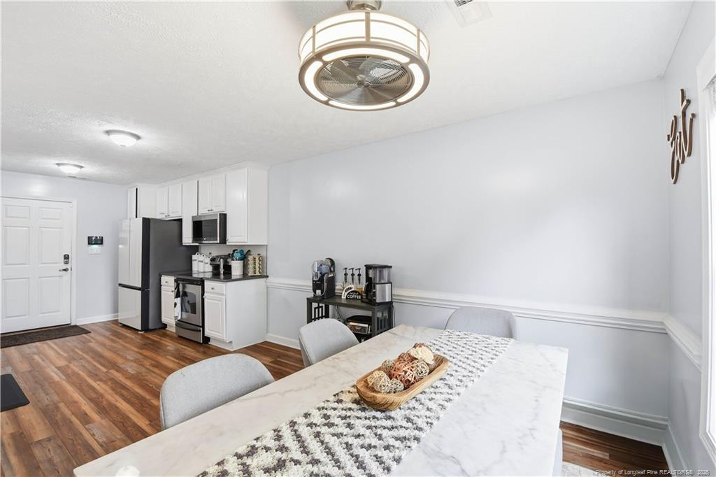 212 Lennox Loop Raeford, NC 28376 - Photo 11 of 47 a bedroom with a bed and wooden floor