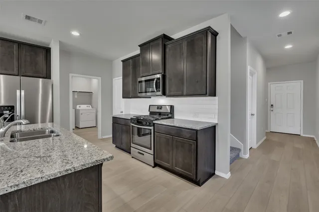 a view of an empty room with a window and fireplace