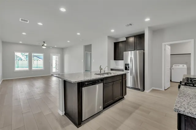 a kitchen with a sink and chandelier