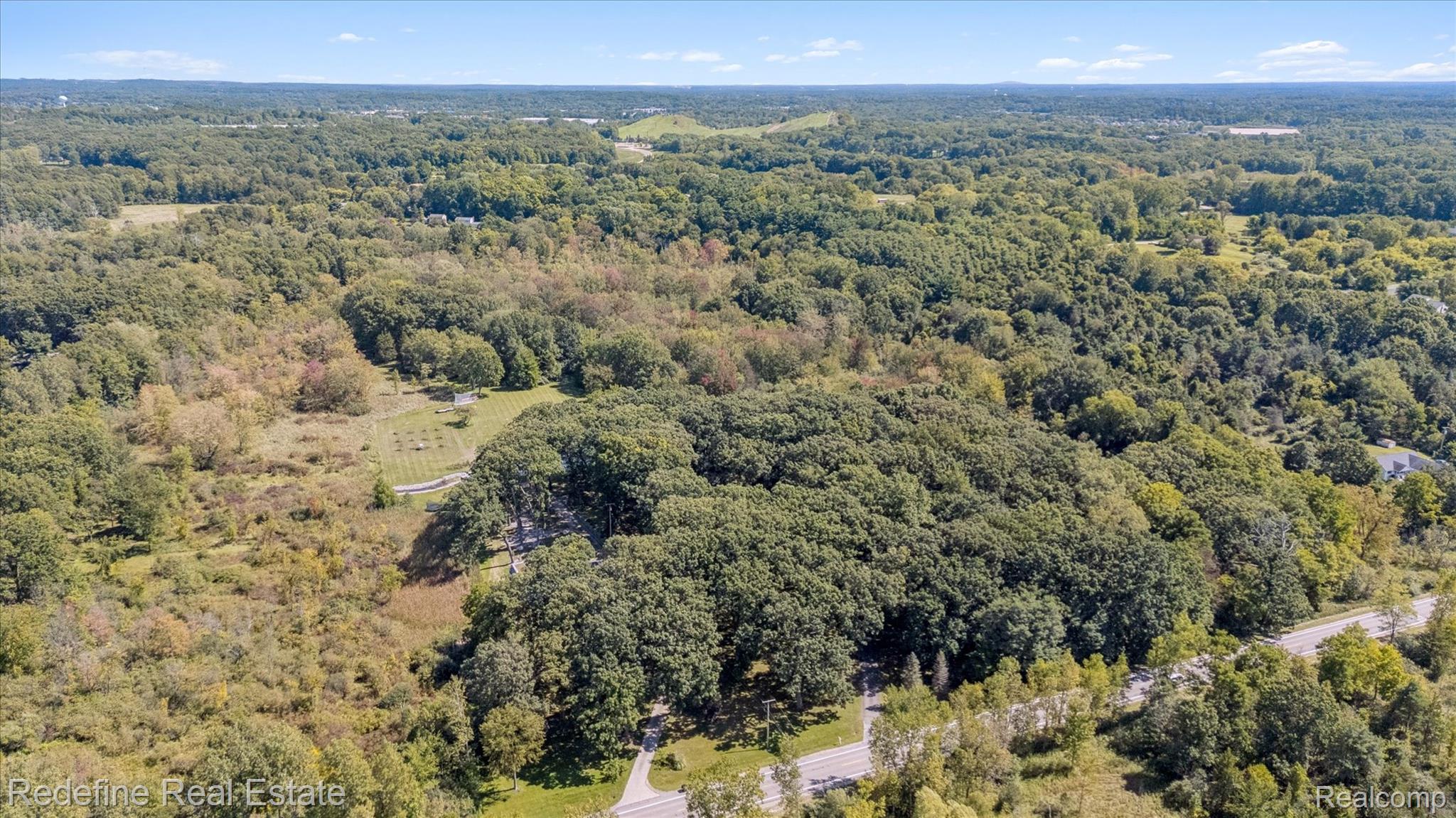 3777 Dorr Road Brighton, MI 48116 - Photo 66 of 77 Aerial view of a heavily wooded area
