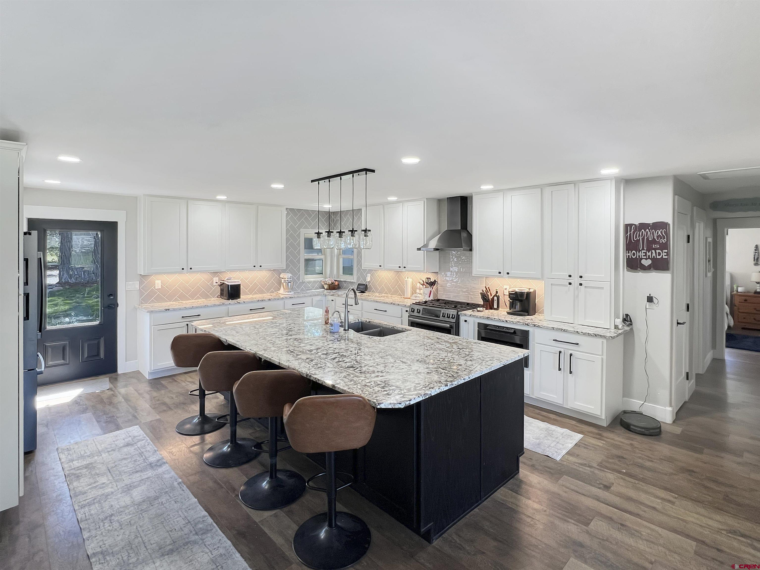 14332 G Road Delta, CO 81416 - Photo 13 of 35 a open kitchen with stainless steel appliances granite countertop a table chairs sink refrigerator and cabinets