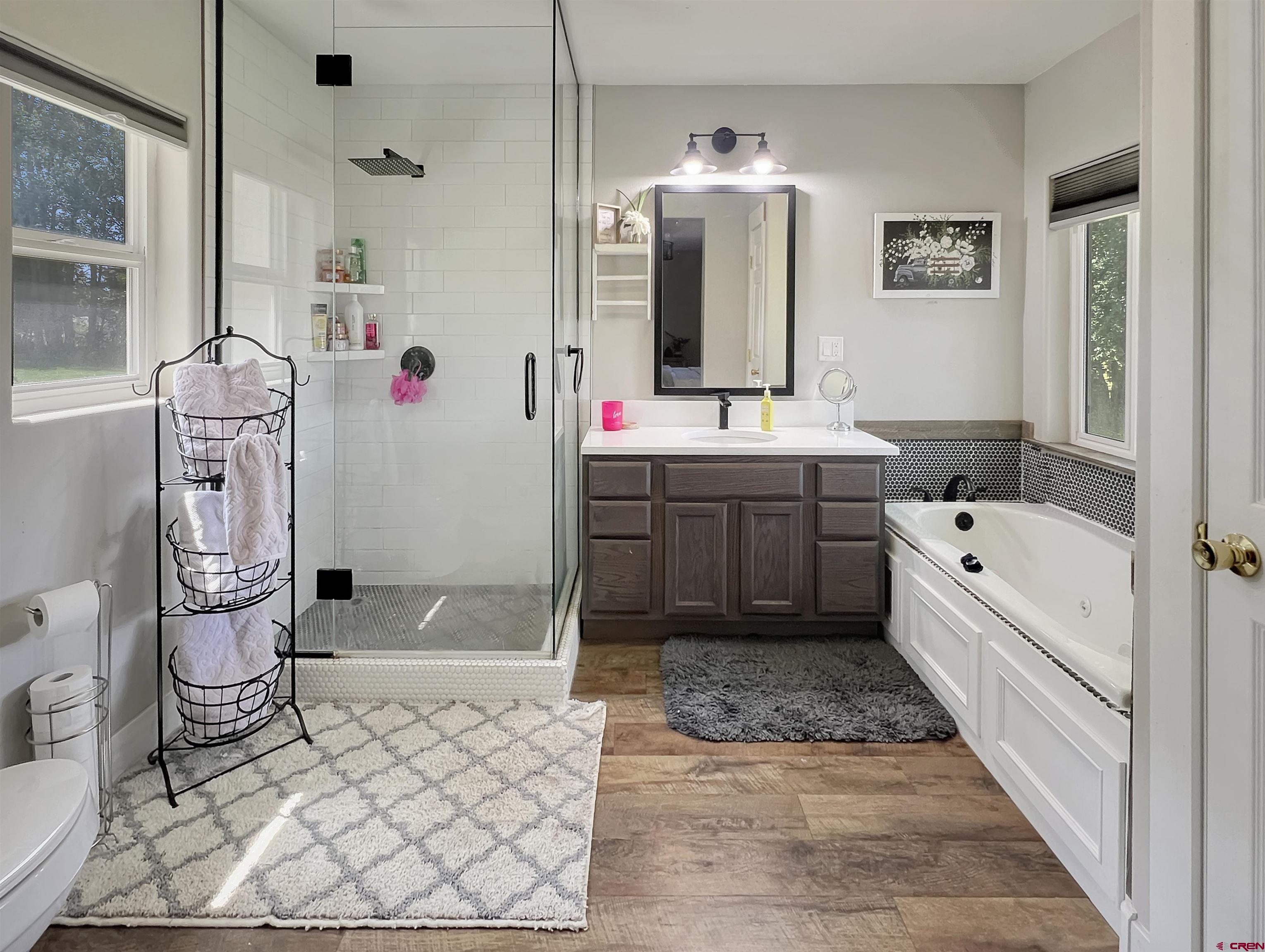 14332 G Road Delta, CO 81416 - Photo 23 of 35 a spacious bathroom with a tub sink and mirror