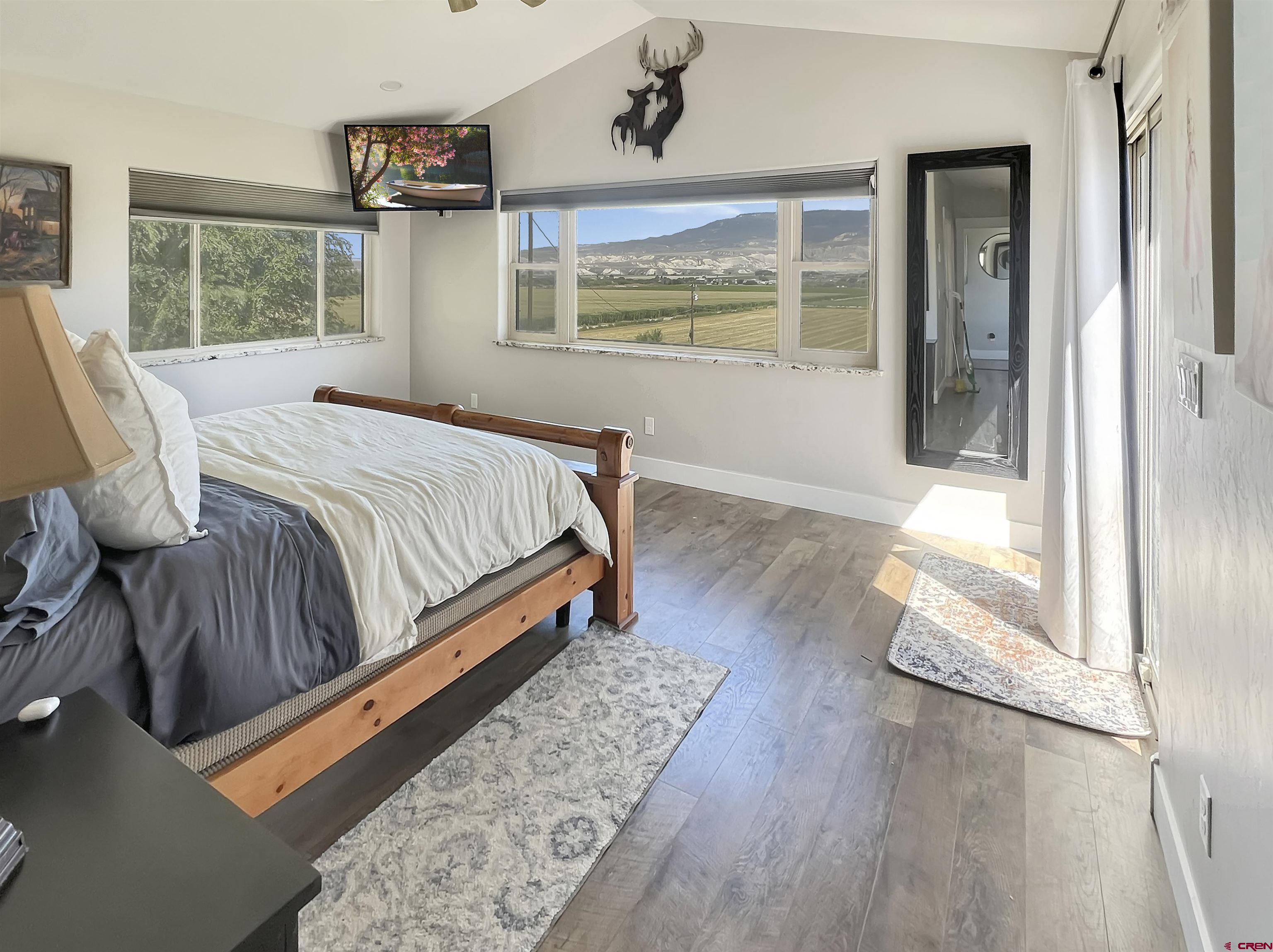14332 G Road Delta, CO 81416 - Photo 28 of 35 a bedroom with a bed and wooden floor
