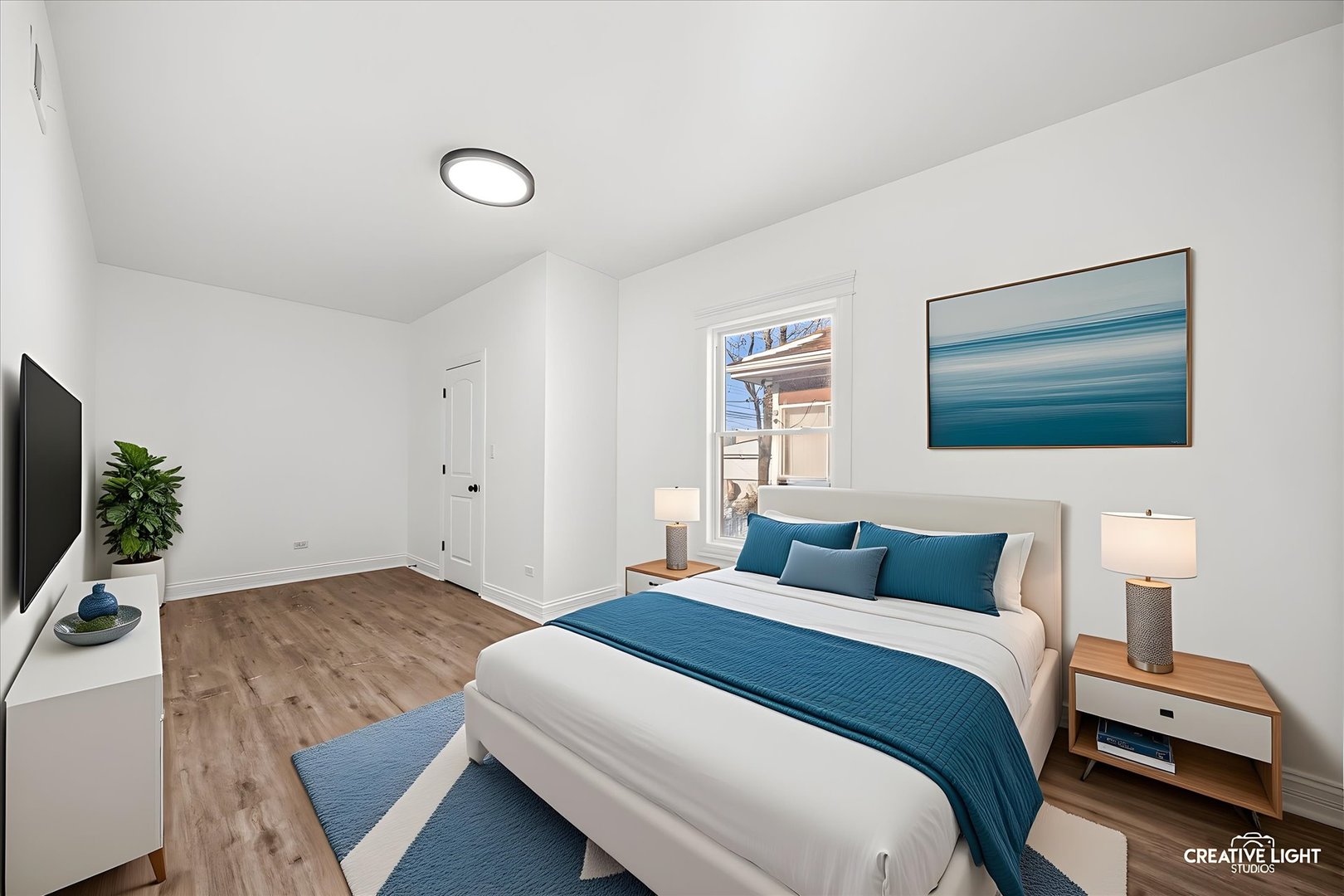 7724 South Chappel Avenue Chicago, IL 60649 - Photo 11 of 22 a bedroom with a bed and a flat screen tv