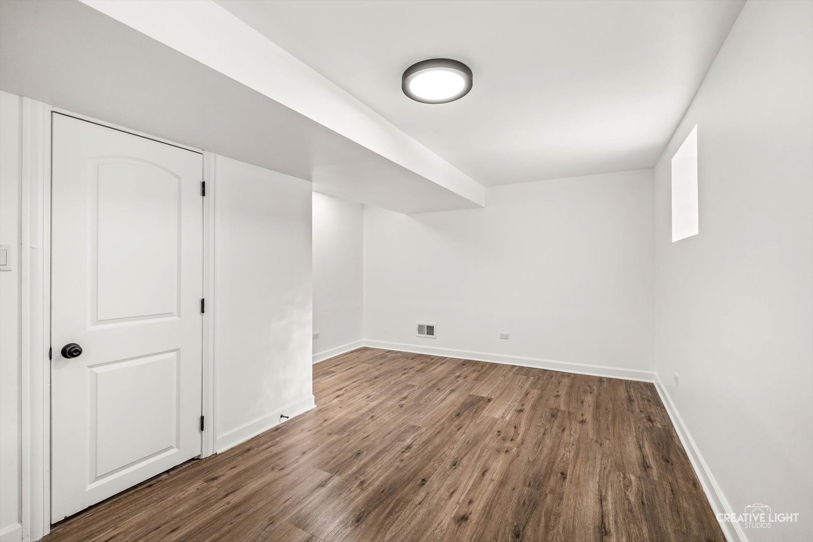 7724 South Chappel Avenue Chicago, IL 60649 - Photo 15 of 22 a view of an empty room with wooden floor