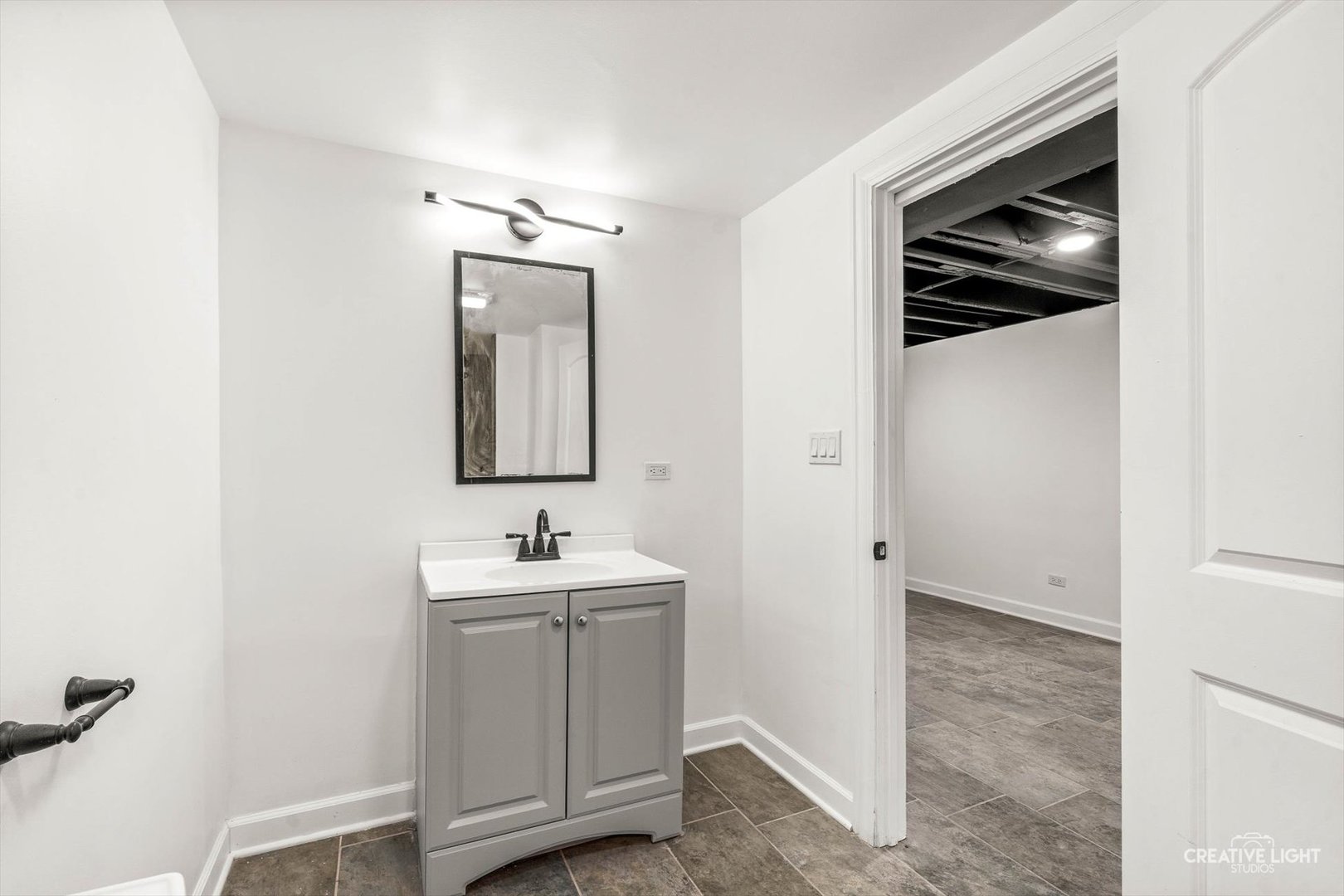7724 South Chappel Avenue Chicago, IL 60649 - Photo 17 of 22 a bathroom with a sink and mirror