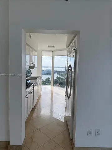 a kitchen with a refrigerator and a sink