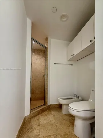a bathroom with a toilet and a shower