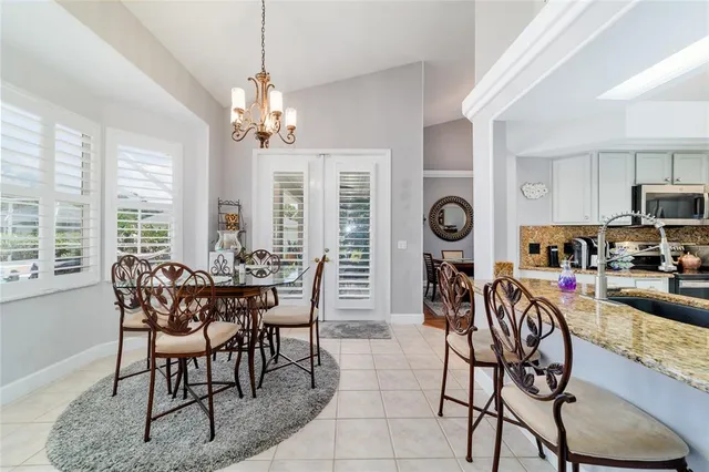 a bed sitting in a bedroom and chandelier
