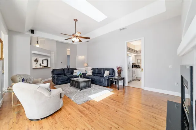 a living room with furniture a flat screen tv and a window