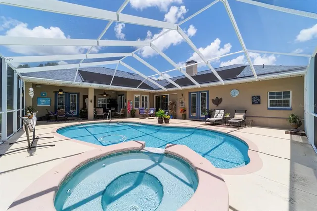 a view of a house with a big yard and potted plants