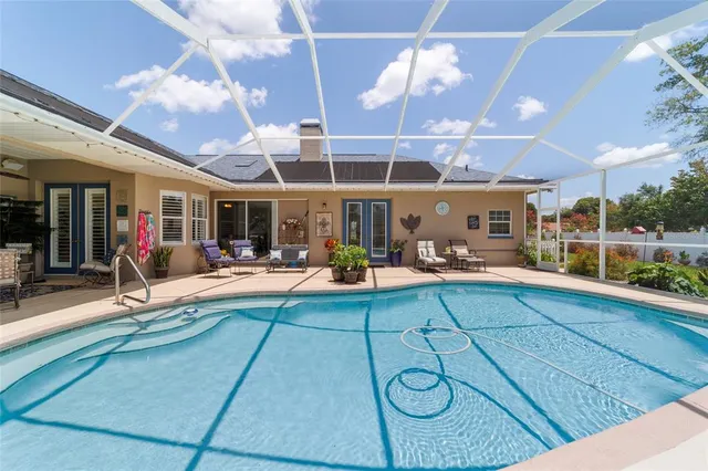 a view of a chairs and table in the backyard