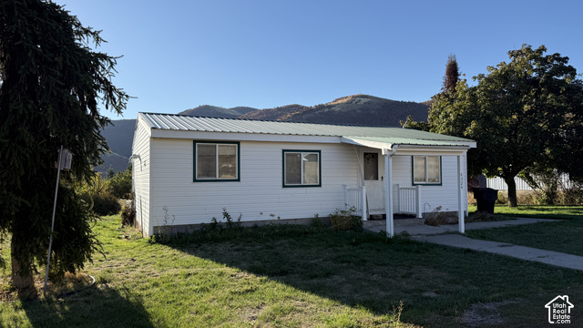 4324 East Cub Road Preston, ID 83263 - Photo 1 of 16 White siding exterior with a green metal roof