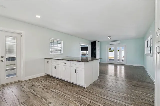 a large white kitchen with window