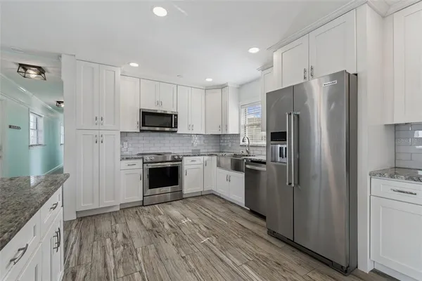 a kitchen with a refrigerator stove and microwave