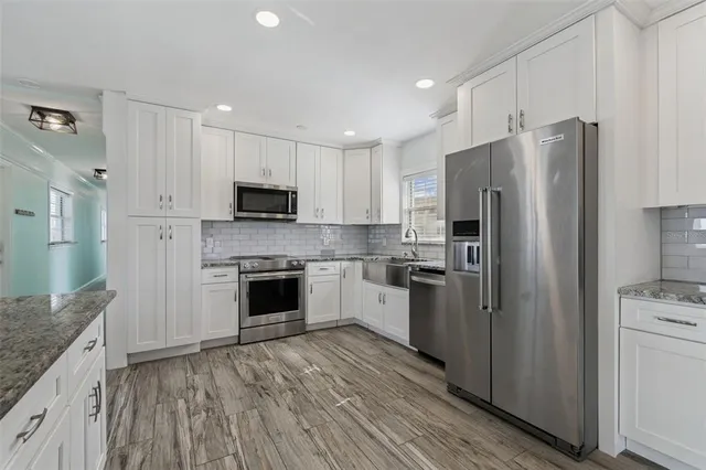 a kitchen with a refrigerator stove and microwave
