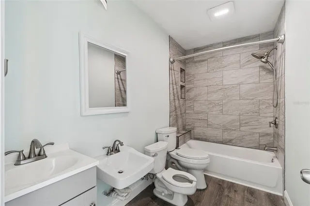 a bathroom with a sink toilet and shower