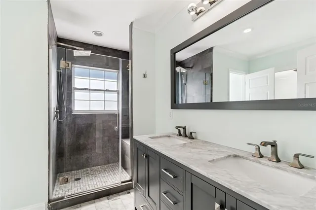 a bathroom with double sink and a mirror