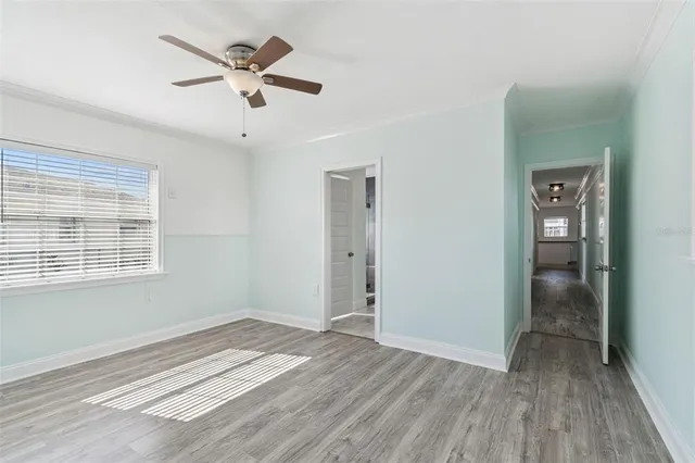 wooden floor in an empty room with a window