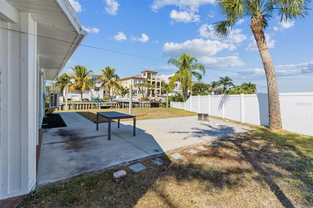 a view of a patio with a table and chairs