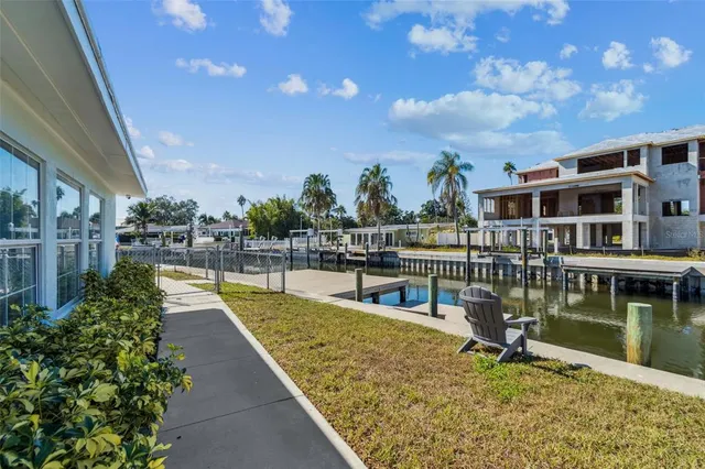 a view of swimming pool with outdoor seating and plants