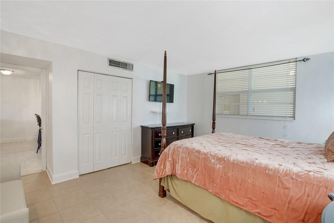 5500 Northwest 2nd Avenue, Unit 119 Boca Raton, FL 33487 - Photo 11 of 22 a bedroom with a bed and a table