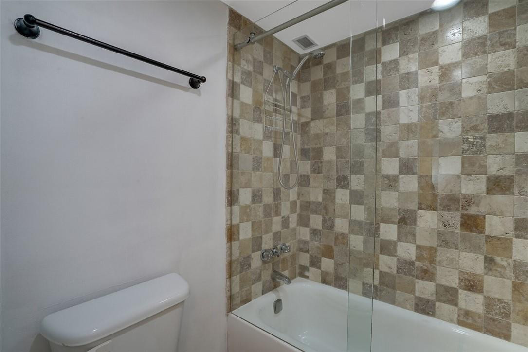 5500 Northwest 2nd Avenue, Unit 119 Boca Raton, FL 33487 - Photo 13 of 22 a bathroom with a white toilet and a bathtub