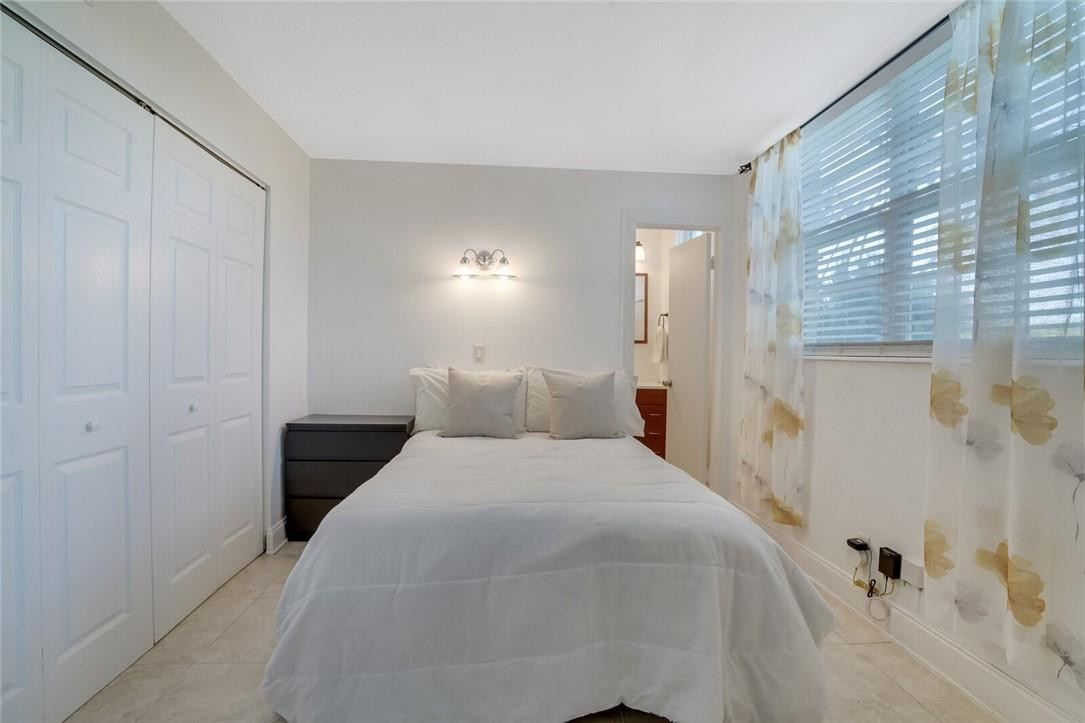 5500 Northwest 2nd Avenue, Unit 119 Boca Raton, FL 33487 - Photo 14 of 22 a bedroom with a bed and a window