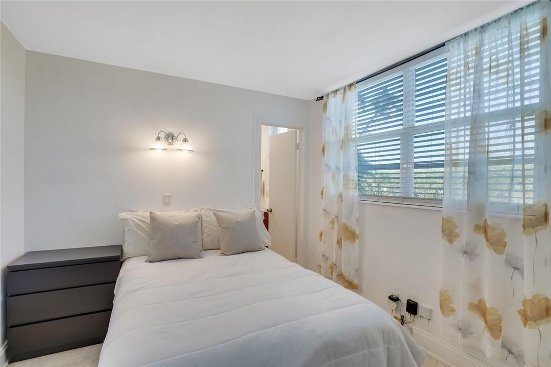 5500 Northwest 2nd Avenue, Unit 119 Boca Raton, FL 33487 - Photo 15 of 22 a bedroom with a bed and a window
