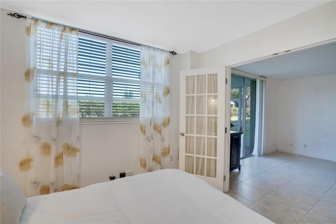 5500 Northwest 2nd Avenue, Unit 119 Boca Raton, FL 33487 - Photo 16 of 22 a bedroom with a bed and a window