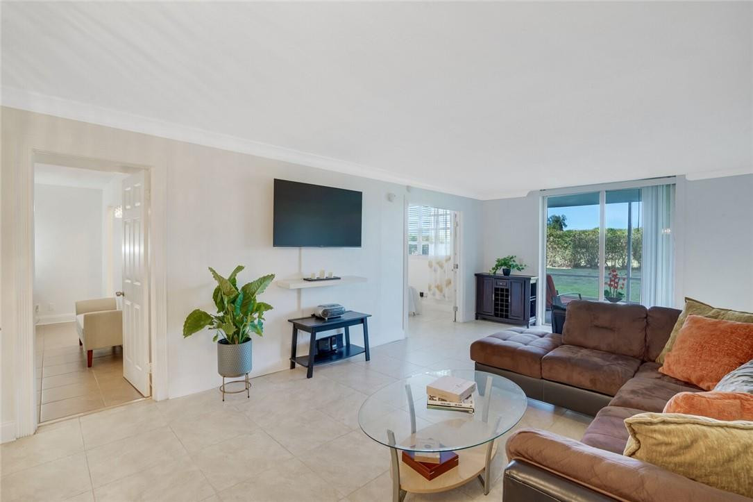5500 Northwest 2nd Avenue, Unit 119 Boca Raton, FL 33487 - Photo 6 of 22 a living room with furniture and a flat screen tv
