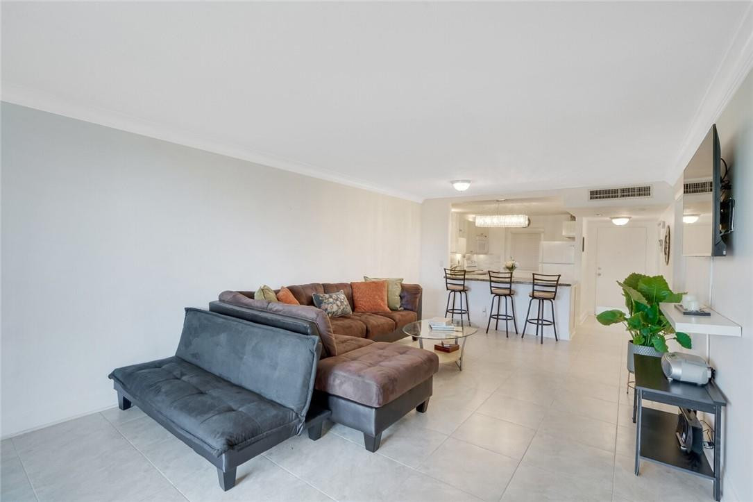 5500 Northwest 2nd Avenue, Unit 119 Boca Raton, FL 33487 - Photo 8 of 22 a living room with furniture and a potted plant