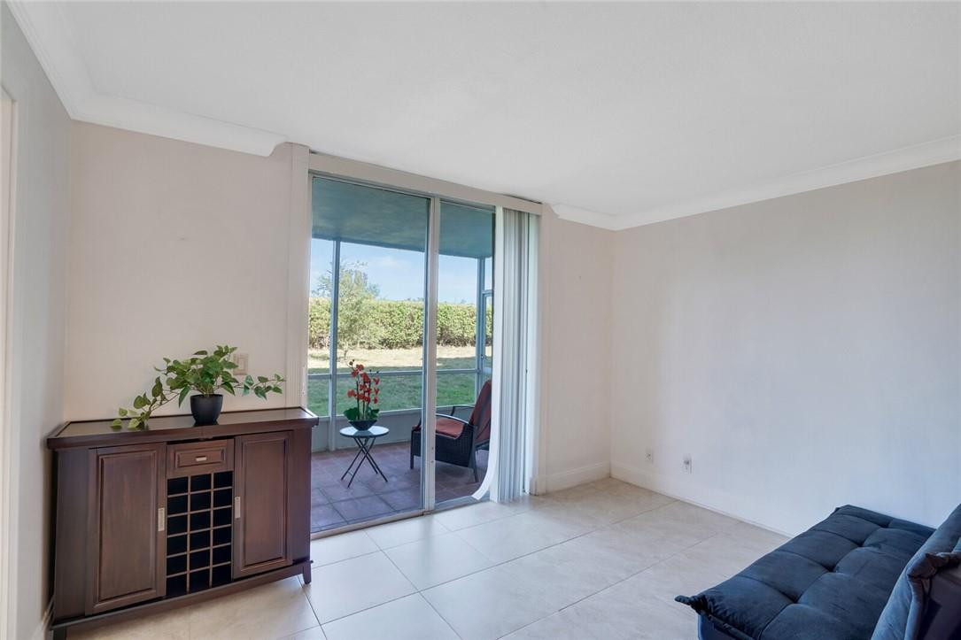 5500 Northwest 2nd Avenue, Unit 119 Boca Raton, FL 33487 - Photo 9 of 22 a living room with furniture and a potted plant