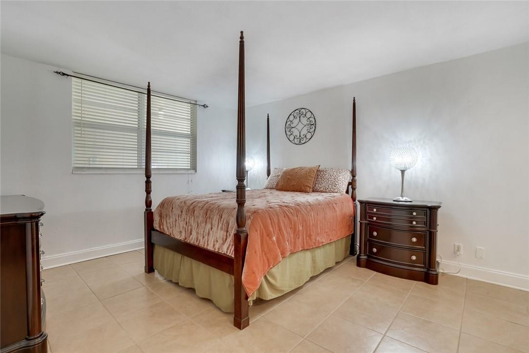 5500 Northwest 2nd Avenue, Unit 119 Boca Raton, FL 33487 - Photo 10 of 22 a spacious bedroom with a bed and a window